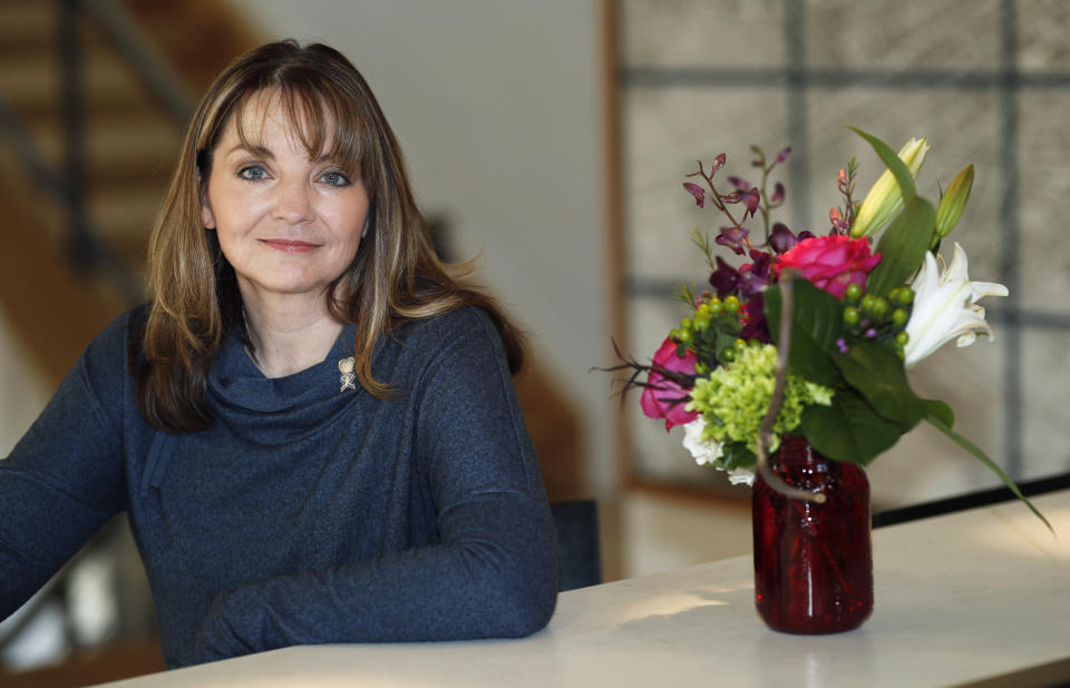 Coni Sanders, whose father was a teacher killed in the 1999 shooting at Columbine High School, poses for a photo at her home Saturday, March 16, 2019, in Denver. A growing movement is urging news organizations to avoid naming the gunmen responsible for mass shootings. The idea is to avoid inspiring more shooters who seek infamy and notoriety. "The media was so fascinated, and so was our country and the world, that they really grasped onto this every detail. Time and time again, we couldn’t escape it," Sanders said. (AP Photo/David Zalubowski)