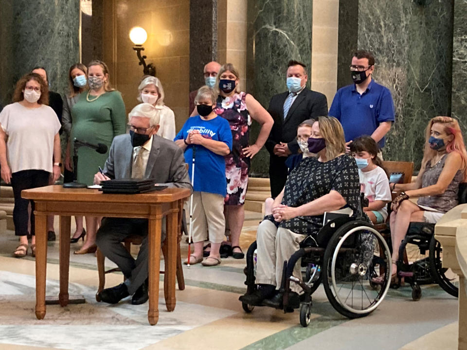 Wisconsin Gov. Tony Evers vetoes Republican bills that would have made it more difficult to vote absentee in the battleground state during a news conference in the Capitol rotunda on Tuesday, Aug. 10, 2021, in Madison, Wis. (AP Photo/Scott Bauer)