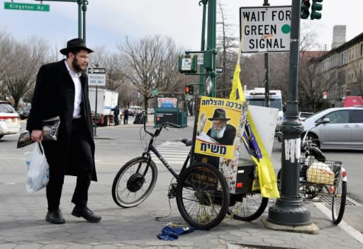 An Orthodox Jewish man walks in the Brooklyn neighborhood of Crown Heights in New York where residents are trying to understand a spate of anti-Semitic attacks that has brought back painful memories