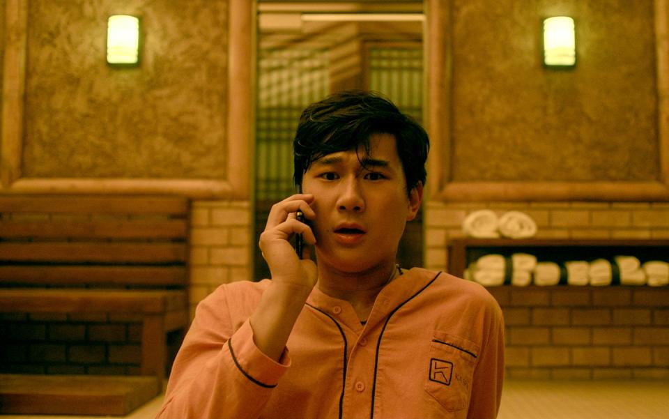 sam song li as bruce sun on the phone in the brothers sun