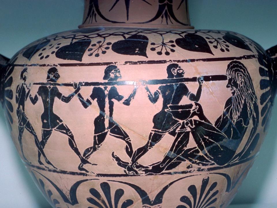 A view of the side of a clay vase found in an Etruscan tomb, painted with four black figures in profile pushing a spear into the eye of Polyphemus the Cyclops, illustrating the episode in the Odyssey.