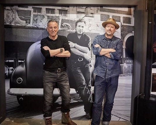 Bruce Springsteen and Danny Clinch pose in front of a Springsteen photo taken by Clinch at the Transparent Clinch Gallery in Asbury Park on Jan. 21, 2022.