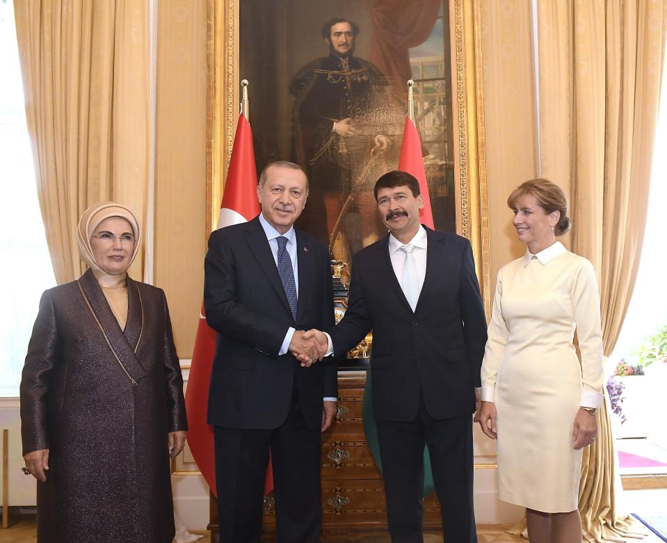 Turkish President Recep Tayyip Erdogan, second left, shakes hands with Hungarian President Janos Ader as their wives Emine Erdogan, left, and Anita Herczegh, right, look on during their meeting the presidential Alexander Palace in Budapest, Hungary, Monday, Oct. 8, 2018. Erdogan is paying a two-day official visit to Hungary. (Tamas Kovacs/MTI via AP)