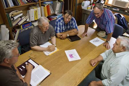 A group of 5 "Secession Committee" members looking over maps and discussing details of the proposed secession territory of Lyndon during a meeting in Caribou, Maine July 18, 2014. REUTERS/Dave Sherwood