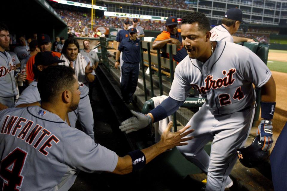 Detroit Tigers' Omar Infante (4) congratulates Miguel Cabrera (24) on his second homer of the game against the Texas Rangers on Sunday, May 19, 2013, in Arlington, Texas.