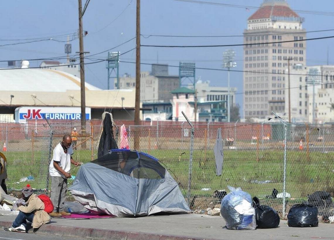 A homeless man sets back up his tent after the daily clean up sweep enforced by the police department as part of the cityâ??s no camping ordinance, where they have to take down their shelters, move then can set them back up.