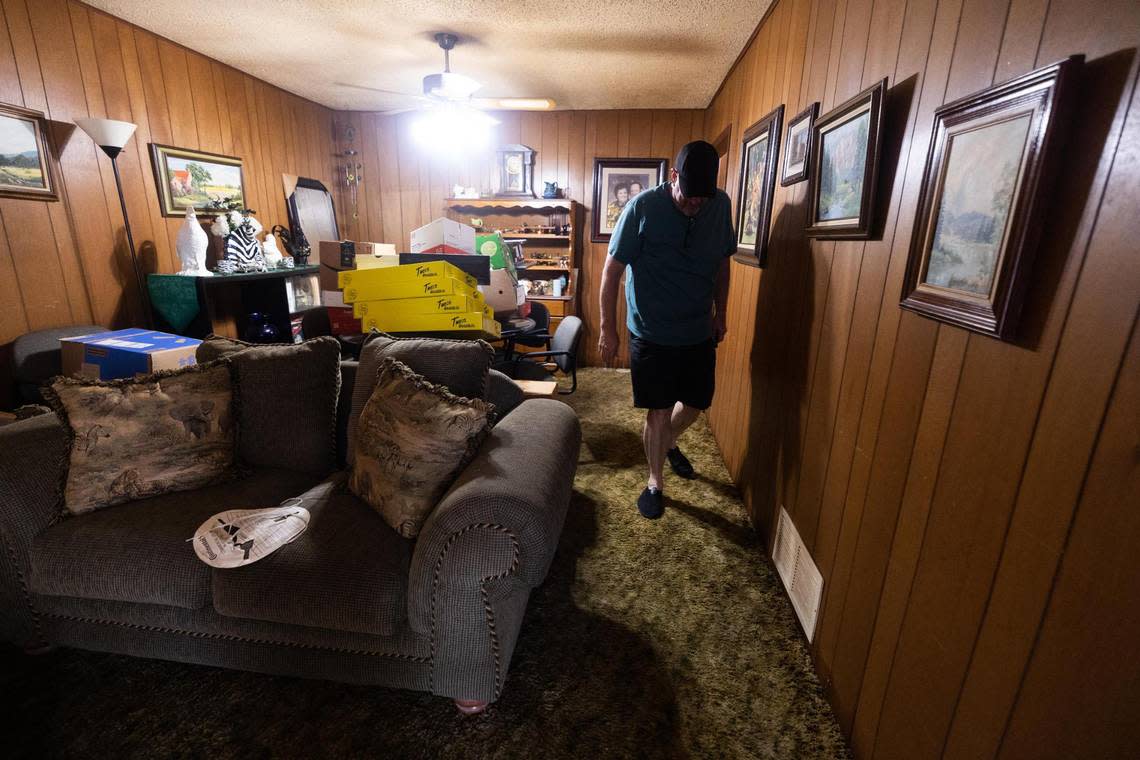 Robby Cross walks on soggy carpet on Tuesday, Aug. 23, 2022, in Haltom City. His home flooded Monday as the area received more than 9 inches of rain.