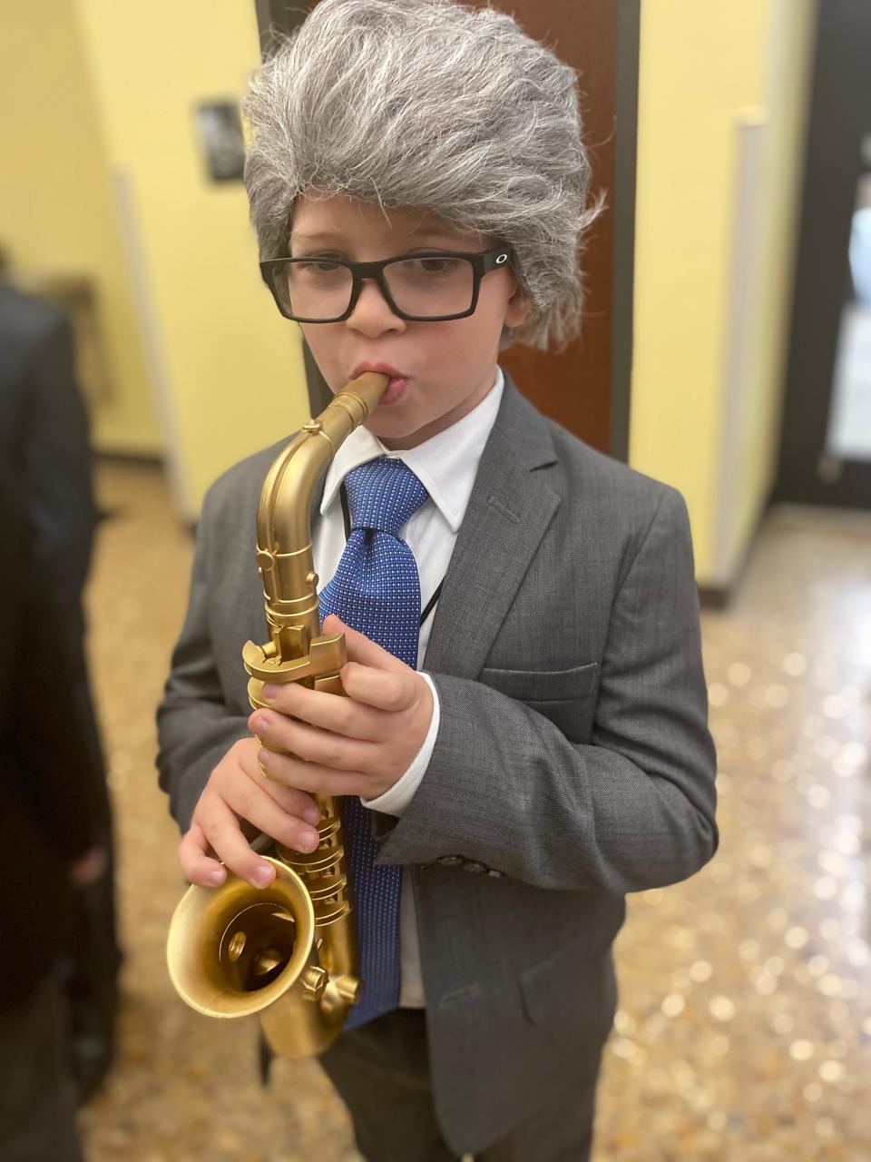 Second-grade student Slade Scioli dressed as former President Bill Clinton during All Saints' annual Hall of Presidents Friday.