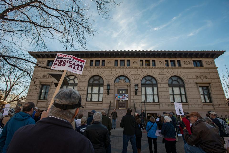 Rich Shannon holds up a sign alongside other supporters who gathered for a "Health For All Universal Health Coverage Day" rally in support of Sen. Bernie Sanders' Medicare for All Bill at the Oak Street Plaza in Fort Collins in December 2017.