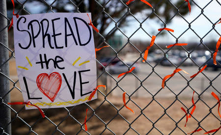 Memorial ribbons are tied on the fence outside Columbine High School after students placed them there during a National School Walkout to honor the 17 students and staff members killed at Marjory Stoneman Douglas High School in Parkland, Florida, in Littleton, Colorado, U.S. March 14, 2018. REUTERS/Rick Wilking