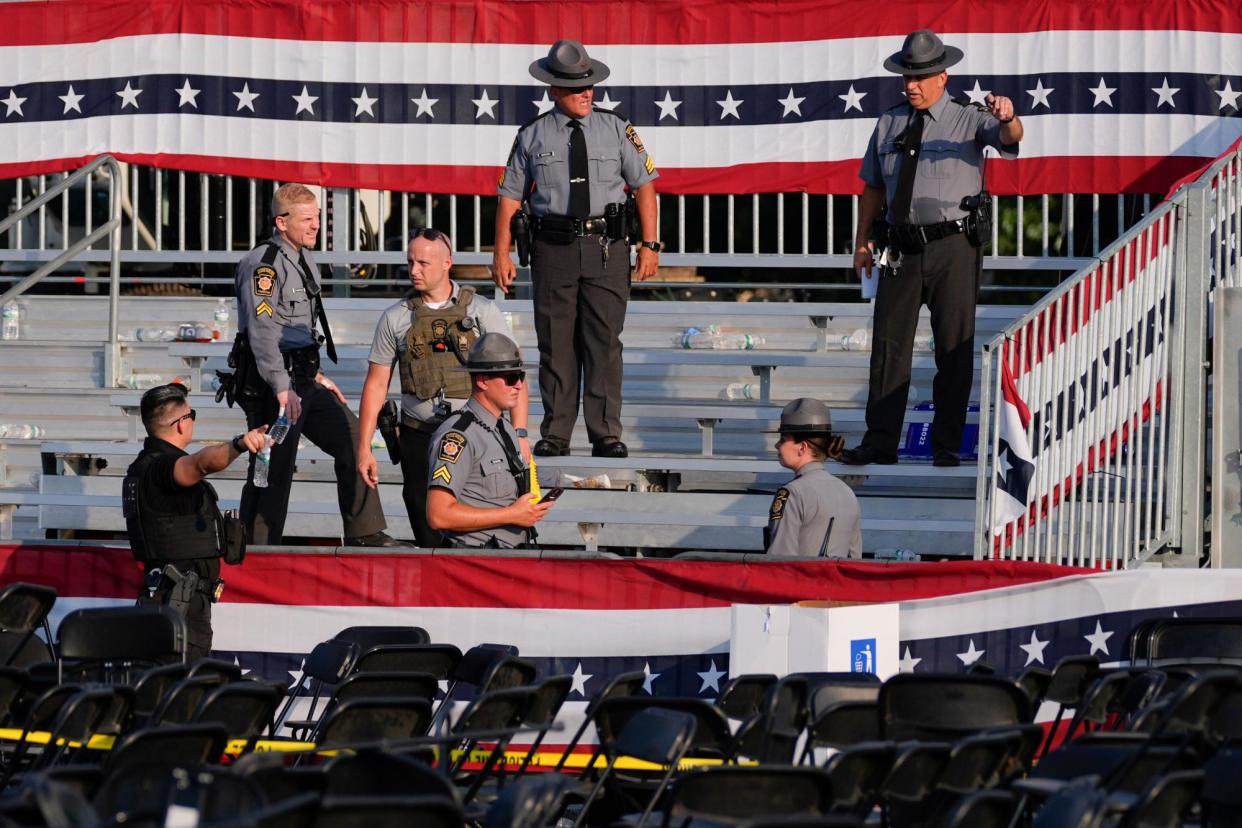 <span>Law enforcement officers respond to the scene of a shooting at a Trump rally in Butler, Pennsylvania, on Saturday.</span><span>Photograph: Evan Vucci/AP</span>