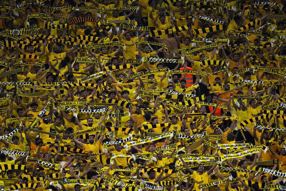 Al Ittihad supporters cheer at the stands during the Soccer Club World Cup first round soccer match between Al Ittihad and Auckland City FC at King Abdullah Sports City stadium in Jeddah, Saudi Arabia, Tuesday, Dec. 12, 2023. Al Ittihad won 3-0. (AP Photo/Manu Fernandez)