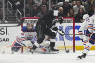 Los Angeles Kings center Anze Kopitar (11) scores against Edmonton Oilers goaltender Stuart Skinner (74) during the first period of Game 4 of an NHL hockey Stanley Cup first-round playoff series hockey game Sunday, April 23, 2023, in Los Angeles. (AP Photo/Ashley Landis)