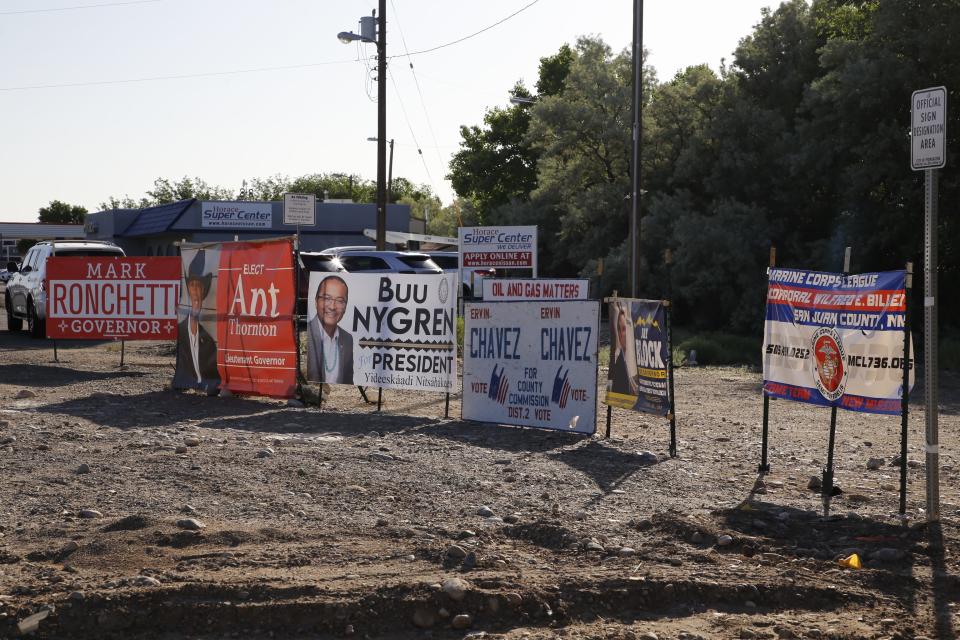 Various campaign signs for the 2022 elections are situated at East Main Street and East 20th Street in Farmington.