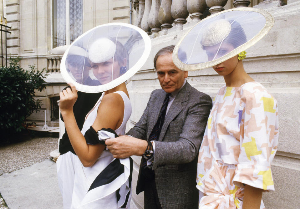 FILE - In this Sept.24, 1984 file photo, Paris couturier Pierre Cardin and models wearing ensembles from the summer 1985 ready-to-wear Cardin collection pose in Paris. France's Academy of Fine Arts says Pierre Cardin, the French designer whose Space Age style was among the iconic looks of 20th-century fashion, has died at 98. (AP Photo/Alexis Duclos, File)