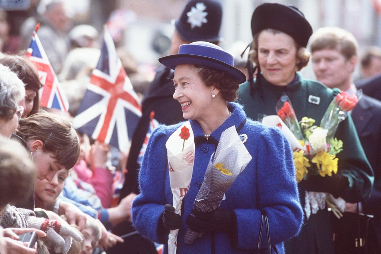 The Queen Attending The Maundy Service At Chichester Cathedral. She Is Receiving Flowers During A Walkabout With Her Lady-in-waiting, The Duchess Of Grafton Standing Behind.