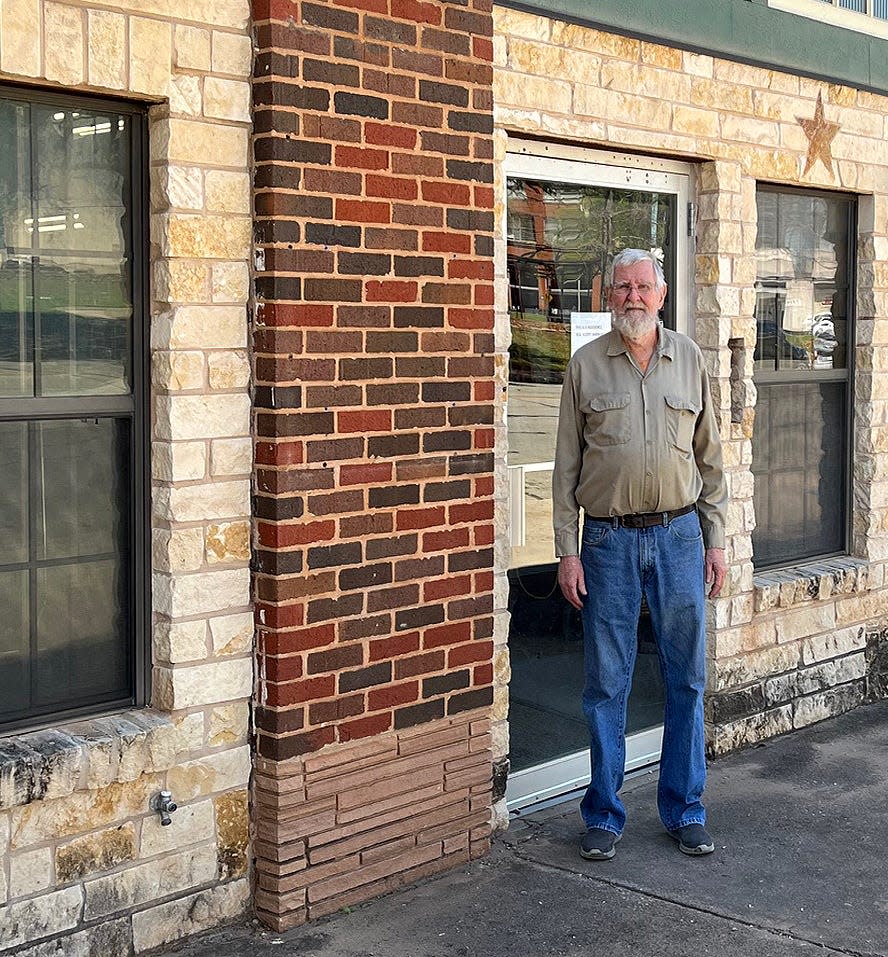 Mike Morford stands at the front of a former stationery store in downtown Wichita Falls on April 4, 2024. He converted the building into his home.