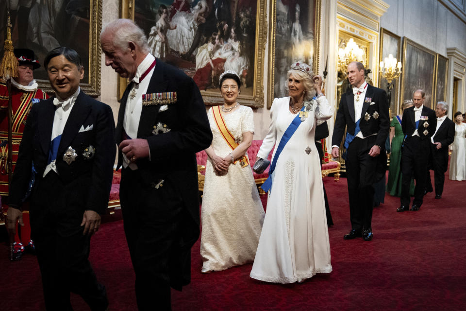 Britain's King Charles III, Emperor Naruhito, left, Empress Masako and Queen Camilla, right, make their way along the East Gallery to attend the State Banquet in London, Tuesday, June 25, 2024, during the State Visit of the Japanese Emperor and Empress to Britain. (Aaron Chown/Pool via AP)