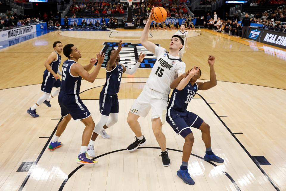 Purdue's Zach Edey shoots past Yale's Matthue Cotton during the second half of a first round NCAA college basketball tournament game Friday, March 18, 2022, in Milwaukee. (AP Photo/Jeffrey Phelps)