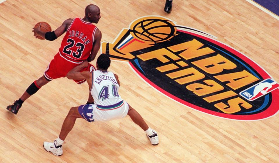 Utah Jazz's Shandon Anderson tries to block Chicago Bulls' Michael Jordan in the second half of Game 6 of the NBA Finals in Salt Lake City, Sunday, June 14, 1998. (AP Photo/Mark J. Terrill)