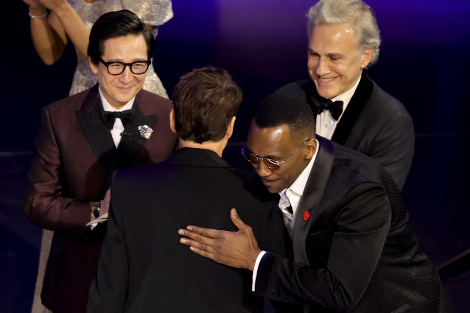 Mahershala Ali hugging RDJ onstage as Christoph and Key Huy smile and look on