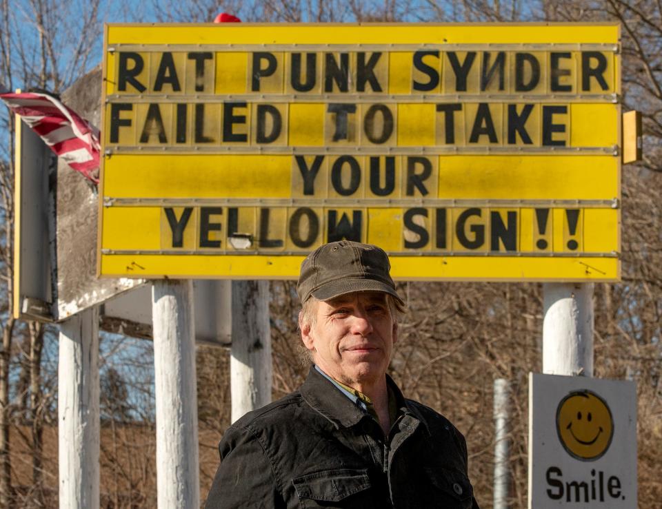 John D. Holdcraft stands by his sign on Route 9 in Brookfield March 4, 2021.