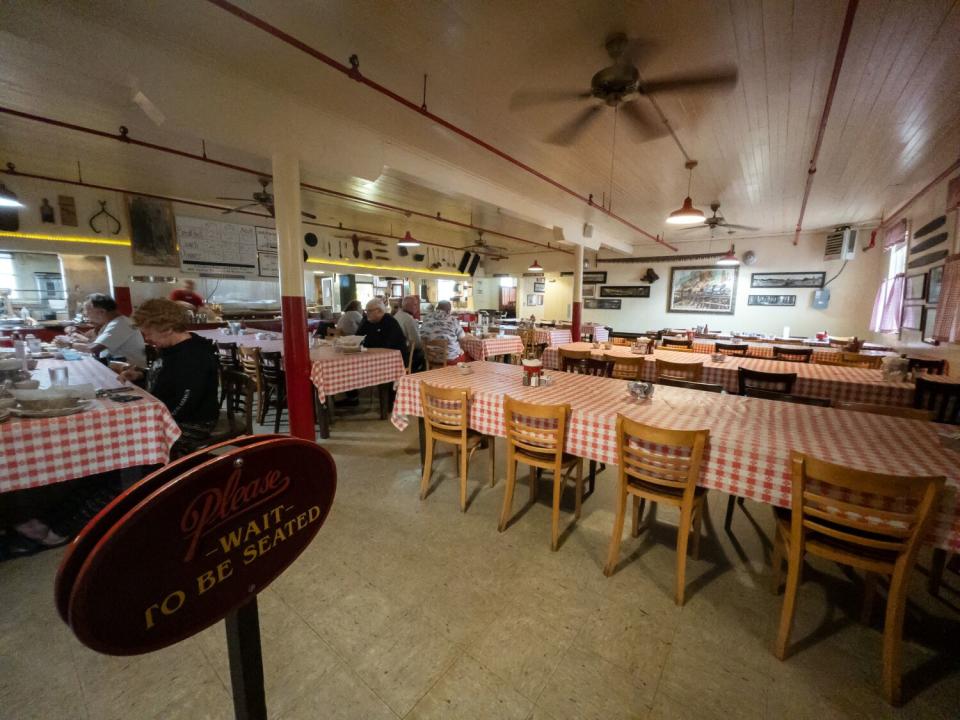 Diners eat inside a restaurant.