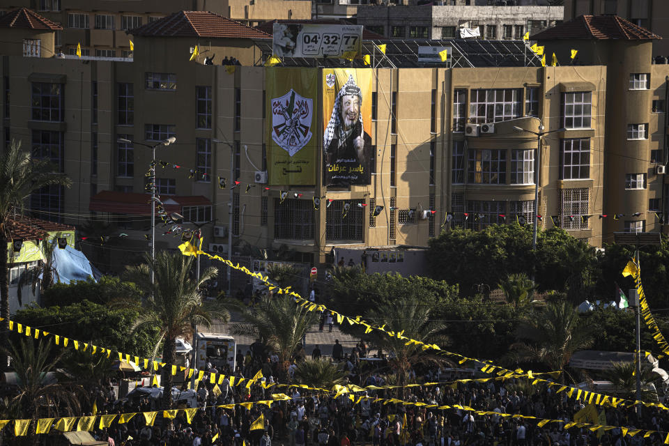 Palestinians wave yellow Fatah movement flags during a rally marking the 18th anniversary of the death of Fatah founder and Palestinian Authority leader Yasser Arafat in Gaza City, Thursday, Nov. 10, 2022. (AP Photo/Fatima Shbair)