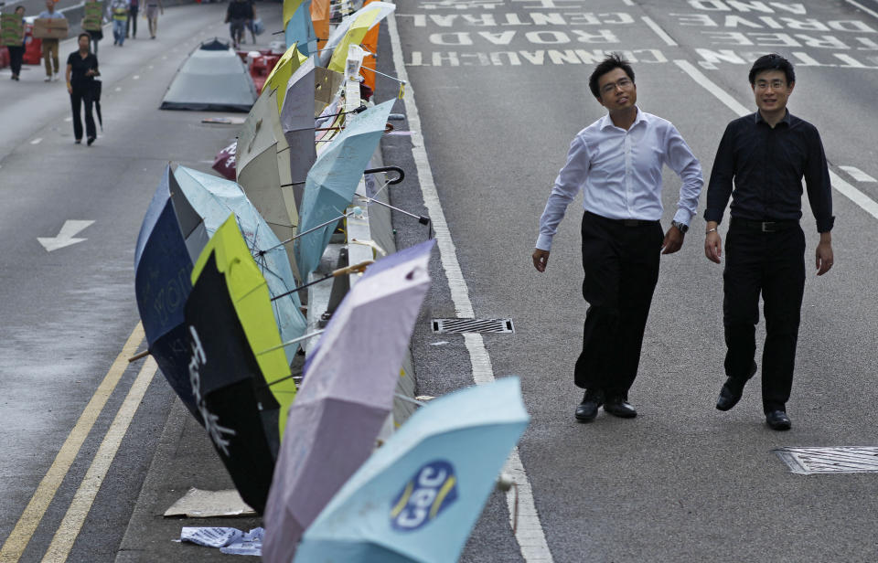 Pedestrians walk through the encampment of pro-democracy student protesters outside the government complex in Hong Kong, Friday, Oct. 3, 2014. (AP Photo/Wally Santana)