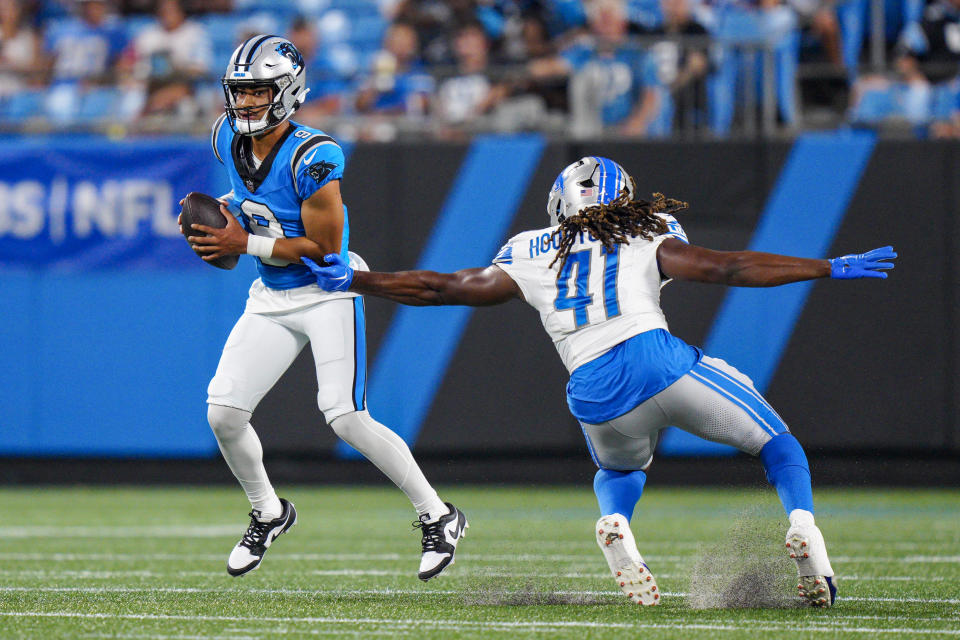 Carolina Panthers quarterback Bryce Young breaks away from Detroit Lions linebacker James Houston during the first half of a preseason NFL football game Friday, Aug. 25, 2023, in Charlotte, N.C. (AP Photo/Jacob Kupferman)