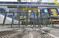 The supporter's entrance of the Signal Iduna Park, Germany's biggest stadium of Borussia Dortmund, is closed in Dortmund, Germany, Thursday, May 14, 2020. Bundesliga will now restart on May 16, 2020 when Borussia Dortmund will play the derby against FC Schalke 04 at home without spectators due to the coronavirus outbreak. (AP Photo/Martin Meissner)