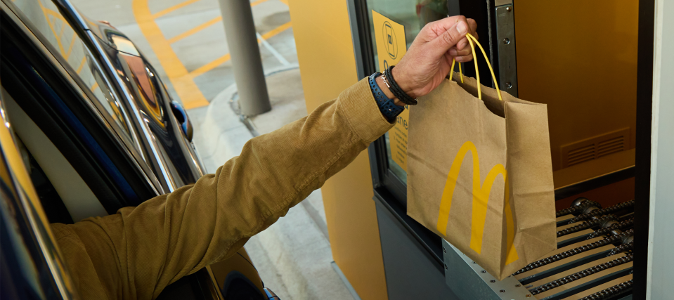 In this company photo, a person demonstrates picking up an order from a fully automated McDonald's near Fort Worth, Texas. / Credit: McDonald's