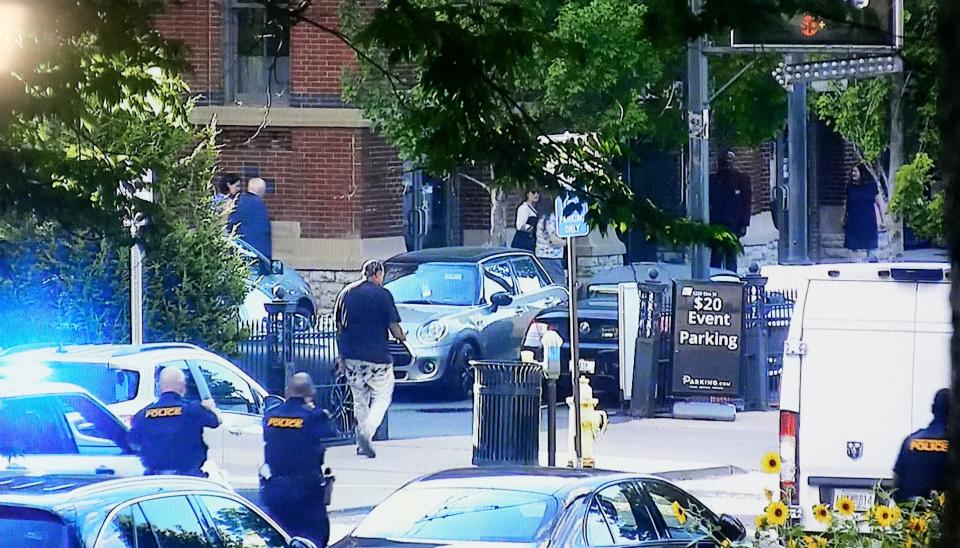 Footage from a Washington Park camera shows Juan Mack, 48, carrying a gun and wearing a dark shirt and bloody white pants, walking towards Music Hall on Elm Street, Thursday, June 27, 2024. The footage was shown during a press conference with Cincinnati police and the city of Cincinnati, over a use of deadly force incident that resulted in the death of Mack in front of Music Hall. 
Friday, June 28, 2024.