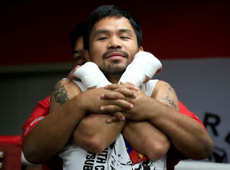 Senator and boxing champion Manny "Pacman" Pacquiao stretches during his training inside the Elorde gym in Pasay city, metro Manila, Philippines September 28, 2016 in preparation for his upcoming bout with Jessie Vargas next month in Las Vegas, U.S.A. Picture taken September 28, 2016. REUTERS/Romeo Ranoco