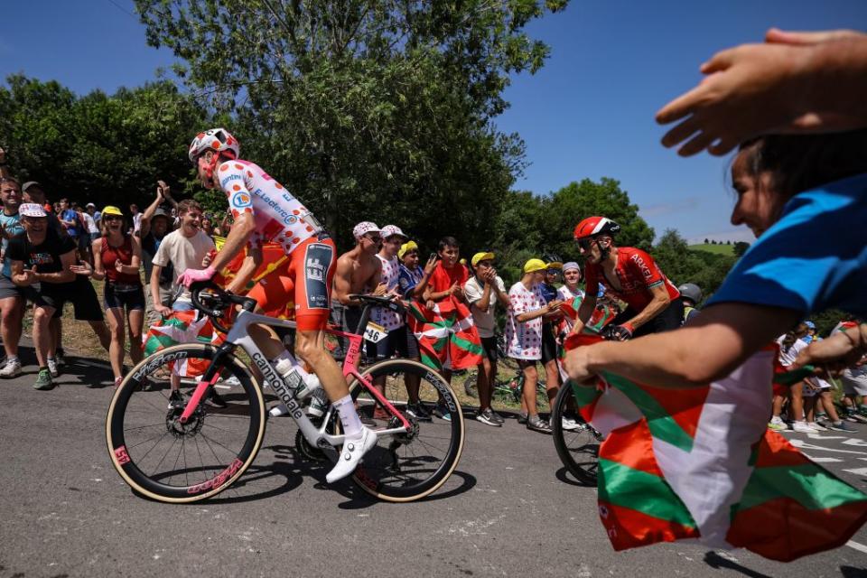 Spectators cheer along the roadside as Team Arkea  Samsics French rider Laurent Pichon R and EF Education  Easyposts US rider Neilson Powless wearing the best climbers polka dot dotted jersey L cycle in a breakaway in the Basque region of Northern Spain during the 3rd stage of the 110th edition of the Tour de France cycling race 1935 km between AmorebietaEtxano in Northern Spain and Bayonne in southwestern France on July 3 2023 Photo by Thomas SAMSON  AFP Photo by THOMAS SAMSONAFP via Getty Images