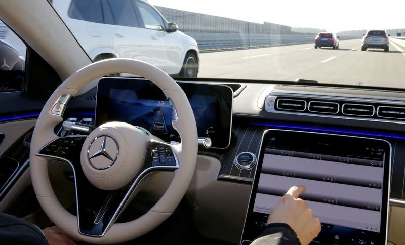 An employee demonstrates steering by autonomous driving system in a new Mercedes-Benz S-Class limousine near Immendingen