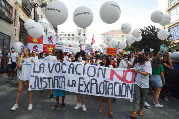 MADRID, SPAIN - JUNE 18: Several people hold a banner reading: 'Vocation does not justify exploitation' during a demonstration against the 