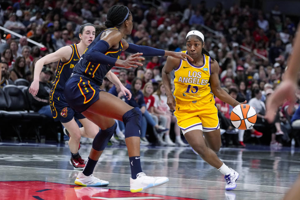 Los Angeles Sparks guard Aari McDonald (15) drives on Indiana Fever center Temi Fagbenle during the second half of a WNBA basketball game in Indianapolis, Tuesday, May 28, 2024. (AP Photo/Michael Conroy)