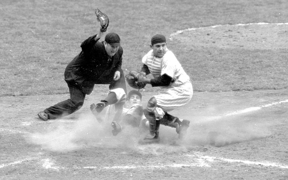 FILE -- In this Oct. 6, 1950, file photo, Philadelphia Phillies shortstop Granny Hamner is tagged at the plate by New York Yankees catcher Yogi Berra as he tries to score from third in the ninth inning of Game 3 of the World Series, at Yankee Stadium in New York. The umpire is Dusty Boggess. The Yankees won 3-2. Game 1 of the 2009 World Series is scheduled for Wednesday Oct. 28 in New York. (AP Photo/File)