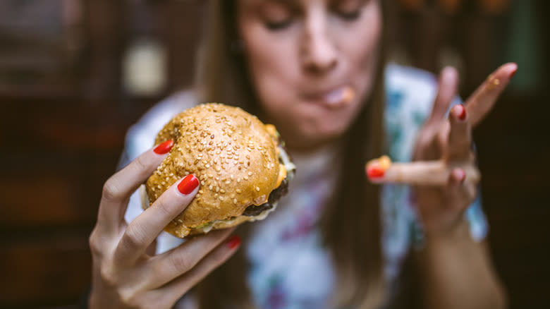 Woman eating messy burger