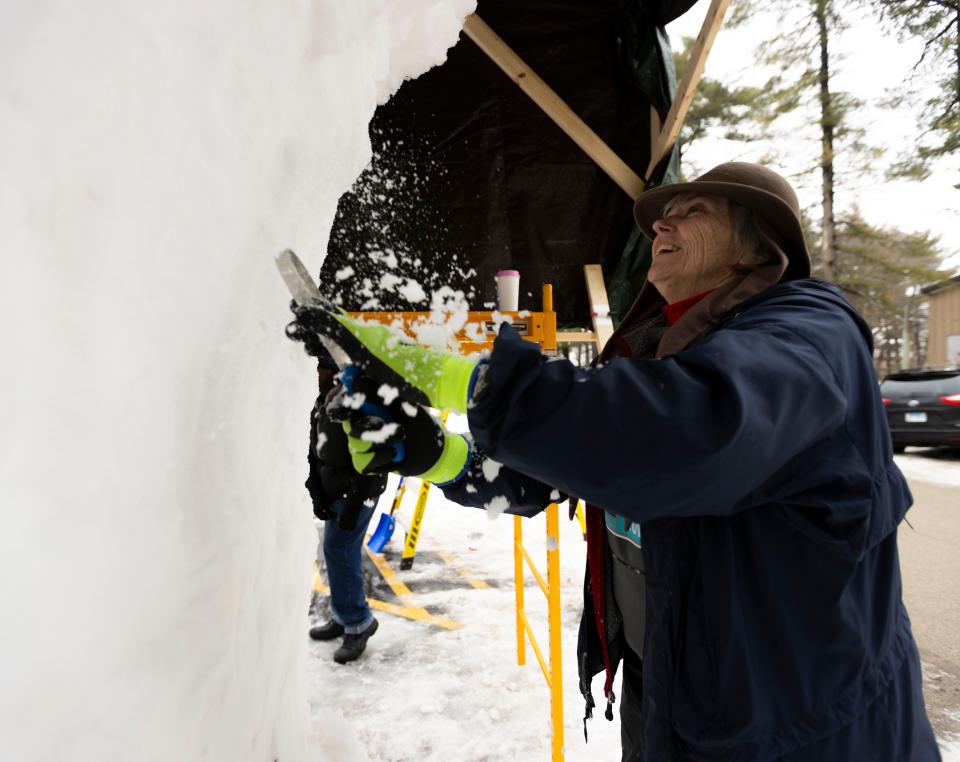 Artist Jacqui Worden works on her team's sculpture during the 38th Annual Illinois Snow Sculpting Competition on Jan. 25, 2024, at Sinnissippi Park.