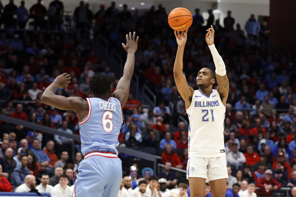 Saint Louis guard Sincere Parker, right, shoots against Dayton guard Enoch Cheeks during the first half of an NCAA college basketball game in Dayton, Ohio, Tuesday, Jan. 16, 2024. (AP Photo/Paul Vernon)