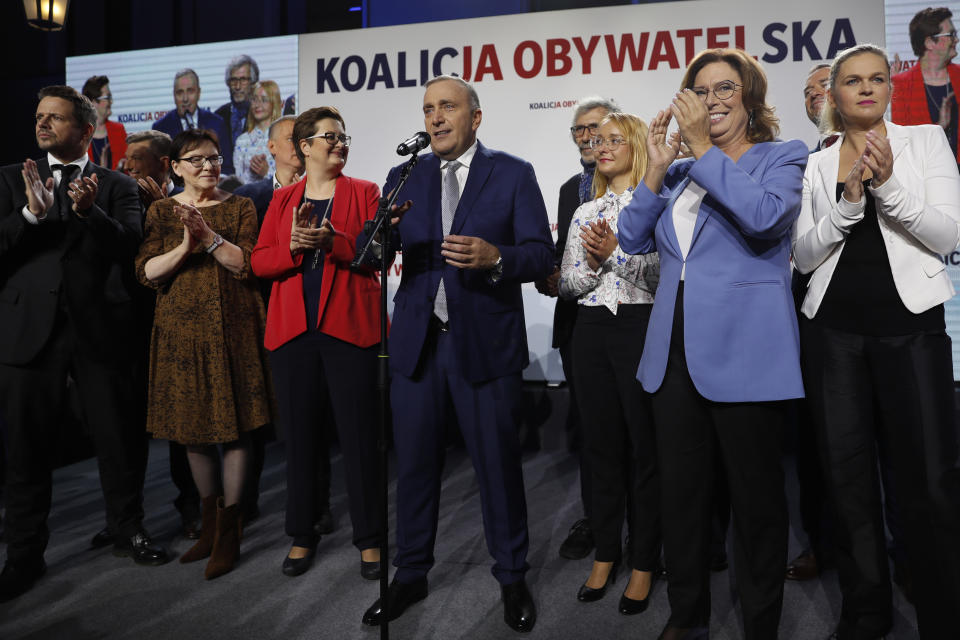 Grzegorz Schetyna, center, one of the leaders of opposition "Civic Coalition" addresses supporters at the coalition headquarters in Warsaw, Poland, Sunday, Oct. 13, 2019. An exit poll indicates that Poland's conservative ruling party Law and Justice has won the most votes in a general election. (AP Photo/Darko Bandic)