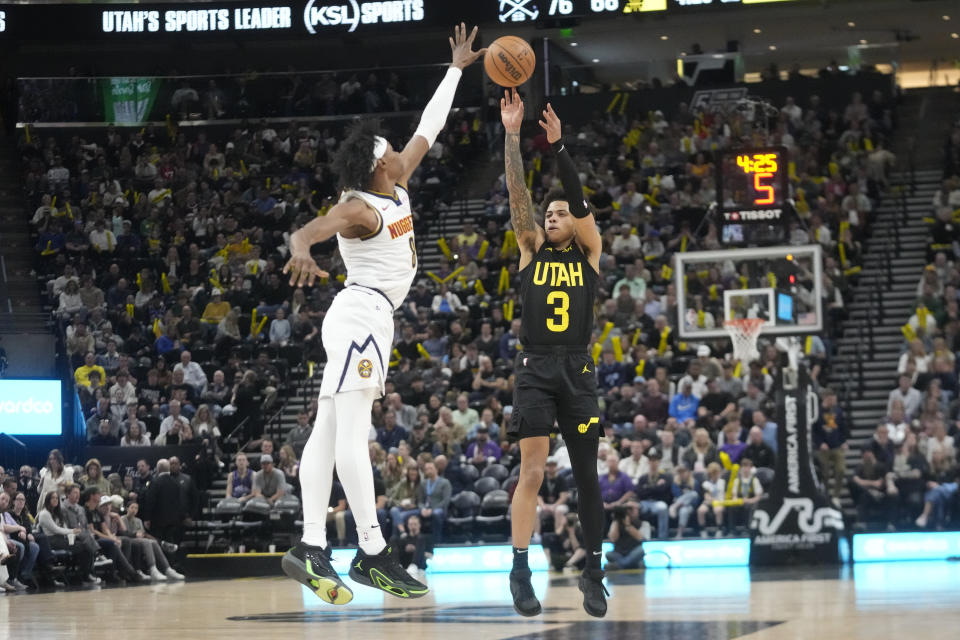 Utah Jazz guard Keyonte George (3) shoots as Denver Nuggets forward Peyton Watson (8) defends during the second half of an NBA basketball game Tuesday, April 9, 2024, in Salt Lake City. (AP Photo/Rick Bowmer)