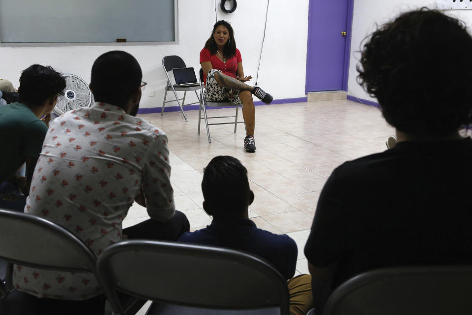 In this Aug. 16, 2019 photo, trans activist Kenya Cuevas talks with young people living with HIV during a weekly support meeting, in Mexico City. Cuevas is one of the most visible trans activists in Mexico among a growing chorus of women seeking change from the government. (AP Photo/Ginnette Riquelme)