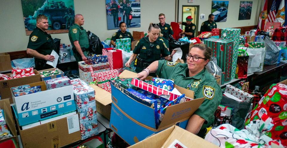 Okaloosa County Sheriffs Office school resource officers pick up their school's Christmas gifts during the annual Angel Tree Toy Drive. Close to 300 students will receive gifts this year.