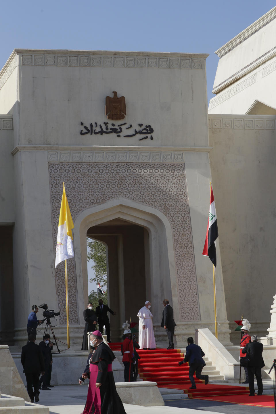 Pope Francis is welcomed by Iraqi President Barham Salih, at Baghdad's Presidential Palace, Iraq, Friday, March 5, 2021. Pope Francis has arrived in Iraq to urge the country's dwindling number of Christians to stay put and help rebuild the country after years of war and persecution, brushing aside the coronavirus pandemic and security concerns. (AP Photo/Andrew Medichini)