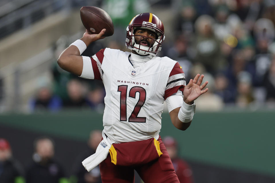 Washington Commanders quarterback Jacoby Brissett (12) passes against the New York Jets during the fourth quarter of an NFL football game, Sunday, Dec. 24, 2023, in East Rutherford, N.J. (AP Photo/Adam Hunger)