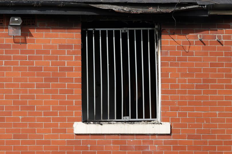 An upstairs window is missing from the house