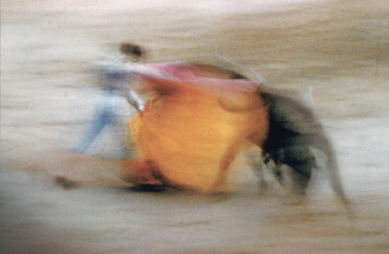  Circa 1970: A matador waves his cloak at a charging bull. 